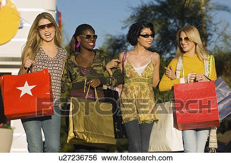 Stylish women with shopping bags, outdoors View Large Photo Image Stock Photograph - Stylish women with shopping bags, outdoors. Fotosearch