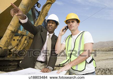 Picture - Surveyor and construction worker with blueprints. Fotosearch