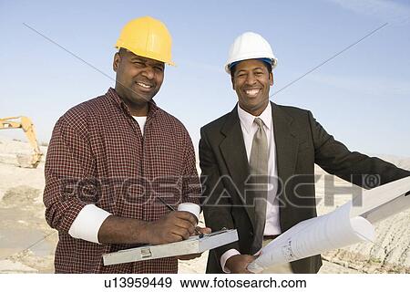 Surveyor and construction worker with blueprints, portrait View Large Photo Image Stock Photo - Surveyor and construction worker with blueprints, portrait. Fotosearch