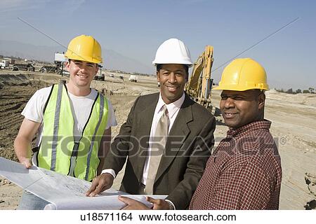 Picture - Surveyor and construction workers on site, portrait. Fotosearch