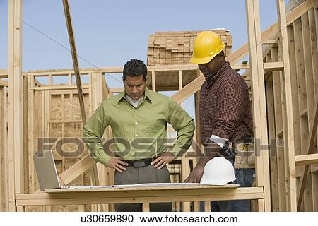 Surveyors working on construction site View Large Photo Image Stock Image - Surveyors working on construction site. Fotosearch