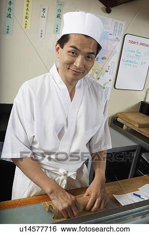 Sushi chef preparing plate of sushi in restaurant View Large Photo Image Stock Photograph - Sushi chef preparing plate of sushi in restaurant. Fotosearch