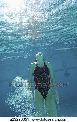 Swimmer coming up for air, underwater View Large Photo Image Stock Image - Swimmer coming up for air, underwater. Fotosearch