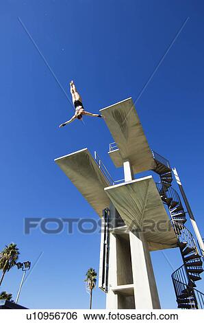 Swimmer diving from diving board View Large Photo Image Stock Photograph - Swimmer diving from diving board. Fotosearch