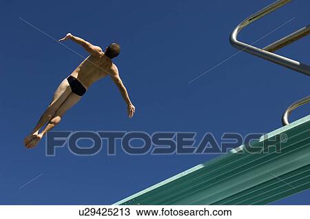Swimmer diving into swimming pool View Large Photo Image Stock Image - Swimmer diving into swimming pool. Fotosearch