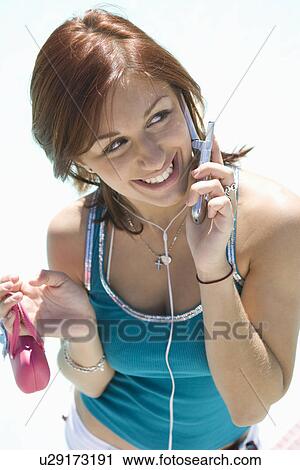 Stock Image - Teenage Girl (18-19) Talking on Mobile, Smiling. Fotosearch