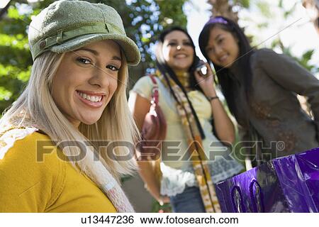 Stock Photograph - Teenage girls (16-17) smiling, outdoors, (portrait). Fotosearch