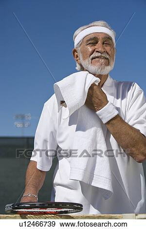 Stock Photo - Tennis player toweling face. Fotosearch