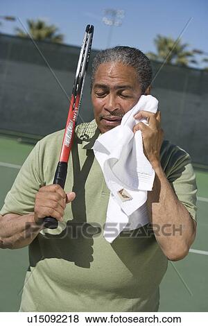 Stock Photo - Tennis player toweling face. Fotosearch