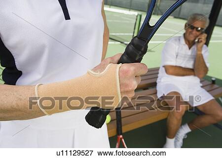 Tennis player wearing wristband View Large Photo Image Stock Photo - Tennis player wearing wristband. Fotosearch