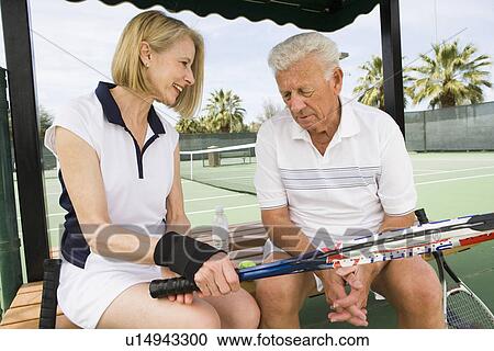 Tennis players sitting on bench View Large Photo Image Stock Image - Tennis players sitting on bench. Fotosearch