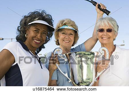 Picture - Tennis players with award cup. Fotosearch