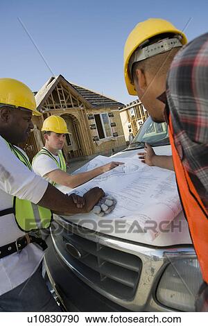 Three construction workers studying blueprint View Large Photo Image Stock Image - Three construction workers studying blueprint. Fotosearch