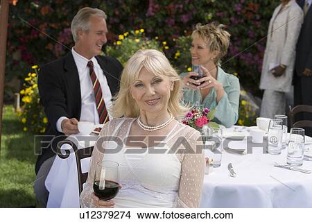 Three friends drinking wine outdoors View Large Photo Image Picture - Three friends drinking wine outdoors. Fotosearch