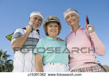 Stock Image - Three tennis players, portrait. Fotosearch