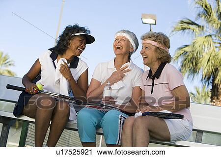 Three women on tennis court View Large Photo Image Stock Image - Three women on tennis court. Fotosearch