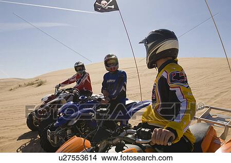Three Young Men on ATVs View Large Photo Image Picture - Three Young Men on ATVs. Fotosearch