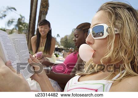 Three Young Women Relaxing Outdoors View Large Photo Image Stock Image - Three Young Women Relaxing Outdoors. Fotosearch