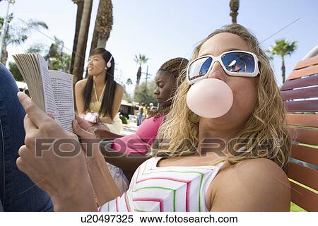Stock Photography - Three young women relaxing outdoors. Fotosearch