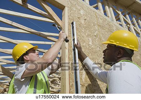 Picture - Two construction workers on site. Fotosearch