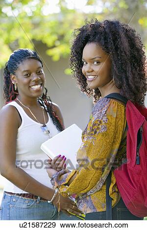 Stock Photo - Two female students smiling, outdoors, (portrait). Fotosearch