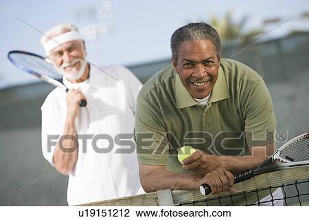 Stock Image - Two male tennis players on court. Fotosearch