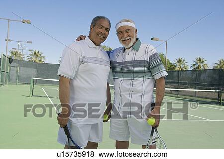 Stock Photo - Two men on tennis court, portrait. Fotosearch