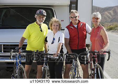 Two Senior couples with bikes on road View Large Photo Image Stock Image - Two Senior couples with bikes on road. Fotosearch