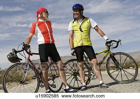 Two Senior men with bikes on road View Large Photo Image Stock Photography - Two Senior men with bikes on road. Fotosearch