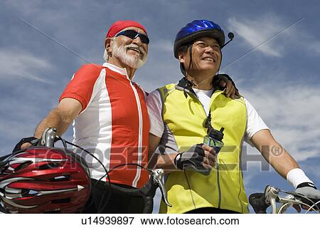 Two Senior men with bikes View Large Photo Image Stock Photo - Two Senior men with bikes. Fotosearch