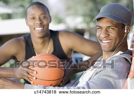 Stock Photo - Two Young Men with Basketball, Portrait. Fotosearch