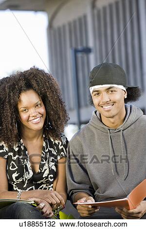 Two young students looking at camera View Large Photo Image Stock Image - Two young students looking at camera. Fotosearch