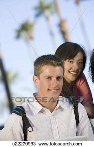 Stock Image - Two young students looking at camera. Fotosearch
