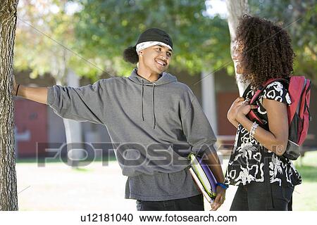 Stock Image - Two young students talking. Fotosearch