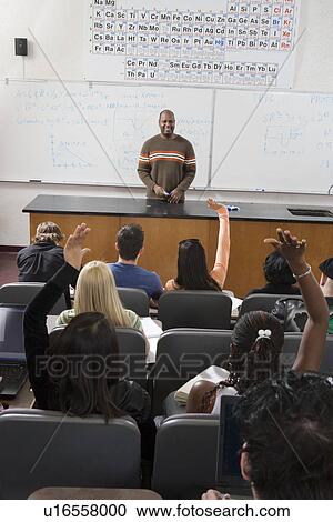 University students raising hands in class View Large Photo Image Stock Image - University students raising hands in class. Fotosearch