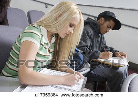 Picture - University students working in lecture hall. Fotosearch