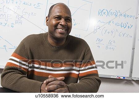 Stock Photograph - University teacher in classroom, portrait. Fotosearch
