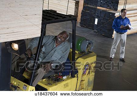 Warehouseman and forklift truck driver View Large Photo Image Picture - Warehouseman and forklift truck driver. Fotosearch