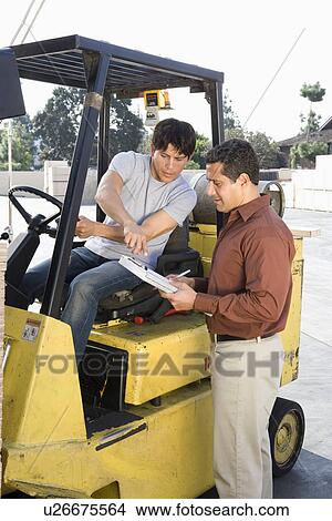 Warehouseman and forklift truck driver View Large Photo Image Picture - Warehouseman and forklift truck driver. Fotosearch