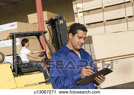 Warehouseman and forklift truck driver View Large Photo Image Stock Image - Warehouseman and forklift truck driver. Fotosearch