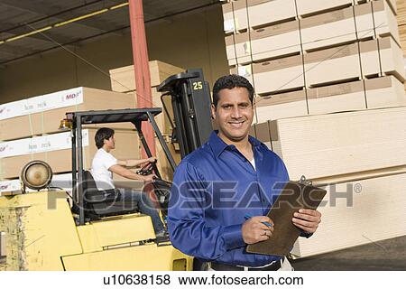 Warehouseman and forklift truck driver View Large Photo Image Stock Photo - Warehouseman and forklift truck driver. Fotosearch