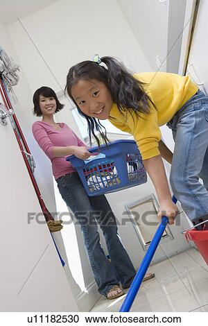 Woman and girl (10-12) doing housework View Large Photo Image Stock Image - Woman and girl (10-12) doing housework. Fotosearch