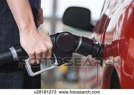 Woman by car with fuel pump View Large Photo Image Stock Image - Woman by car with fuel pump. Fotosearch
