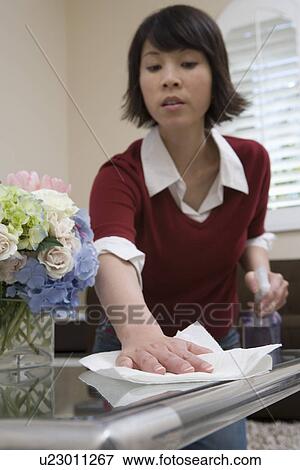 Stock Photo - Woman cleaning table. Fotosearch