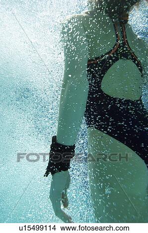 Woman coming up for air, underwater View Large Photo Image Picture - Woman coming up for air, underwater. Fotosearch