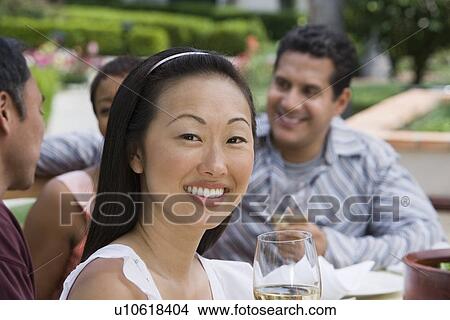 Woman drinking wine with friends outdoors View Large Photo Image Picture - Woman drinking wine with friends outdoors. Fotosearch