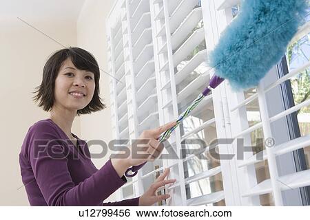 Woman dusting window View Large Photo Image Stock Photograph - Woman dusting window. Fotosearch