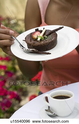 Woman eating dessert outdoors, mid-section View Large Photo Image Stock Photograph - Woman eating dessert outdoors, mid-section. Fotosearch