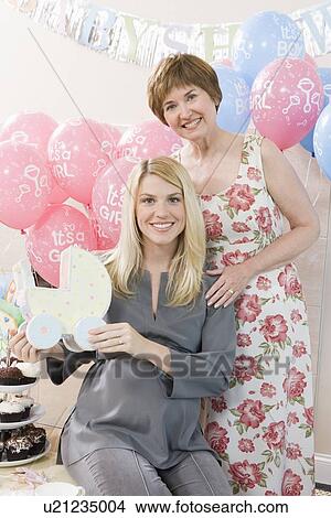 Picture - Woman Holding a Gift at a Baby Shower. Fotosearch