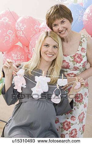 Woman Holding a Gift at a Baby Shower View Large Photo Image Stock Image - Woman Holding a Gift at a Baby Shower. Fotosearch